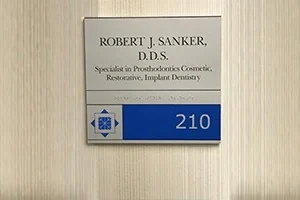 The sign beside the door of Suite 210: Robert J. Sanker, D.D.S., Specialist in Prosthodontics.