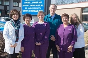 Dr. Sanker and members of the practice team outside 12250 Rockville Pike, below the building's tenant sign.